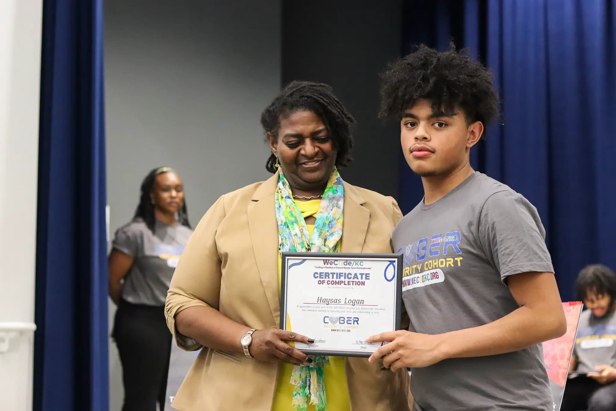WeCode KC student graduating with Cybersecurity certificate